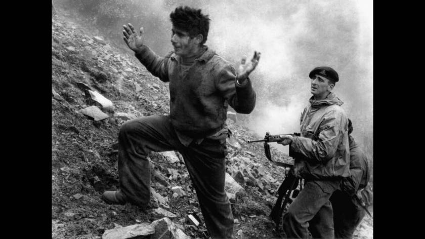 1957
Άγγλος στρατιώτης συλλαμβάνει ένα μέλος της ΕΟΚΑ. Στο καταφύγιο στο οποίο κρυβόταν, στο όρος Τρόοδος, βρισκόταν και ο υπαρχηγός της ΕΟΚΑ, Γρηγόρης Αυξεντίου, τον οποίο οι Άγγλοι είχαν επικηρύξει. Ο Αυξεντίου αρνήθηκε να παραδοθεί και σκοτώθηκε όταν 