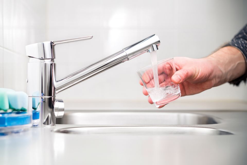 Filling,Glass,With,Tap,Water.,Modern,Faucet,And,Sink,In